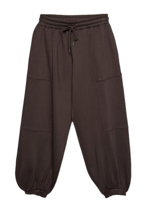 Mørkebrune løstsiddende joggebukser med elastisk talje og ankelflanger, snøre foran og synlige sømdetaljer på benene.