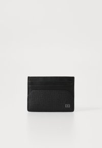 Black leather card holder with textured finish, featuring four card slots and a central pocket. Minimalistic design with subtle hardware detail.