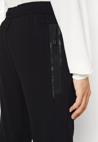 Nike Sportswear Träningsbyxor - black