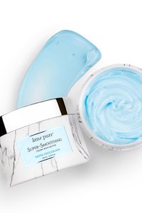 Creamy body butter in a round container, featuring a marble-patterned white and black design. Light blue product visible inside and on the lid.