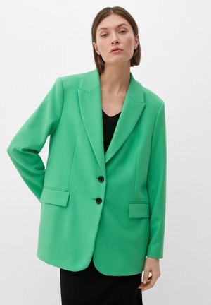 Groene blazer met een tailor-made ontwerp, twee voorzakken en twee zwarte knopen. Beschikt over een notch-kraag en een gladde textuur.