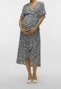 Mekko äidin odotukseen kevyestä, tummansinisestä ja kermanvärisestä kukkakankaasta. Ominaisuuksiin kuuluu V-pääntie, lyhyet hihat ja epäsymmetrinen helma.