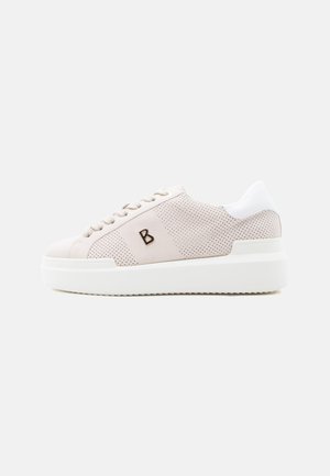 Light beige sneaker with perforated sides, thick white sole, white heel tab, and a small black "B" logo on the side.