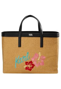 Torba tote z plecioną fakturą, czarne skórzane uchwyty, haft "Karl" w kolorze turkusowym oraz czerwone i różowe wzory hibiskusów na przodzie.