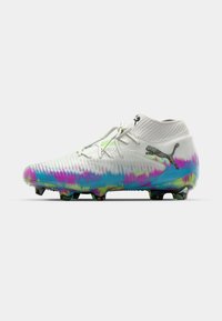 White soccer cleat with colorful tie-dye pattern in pink, blue, and green. Features a high ankle design and textured surface with molded studs.
