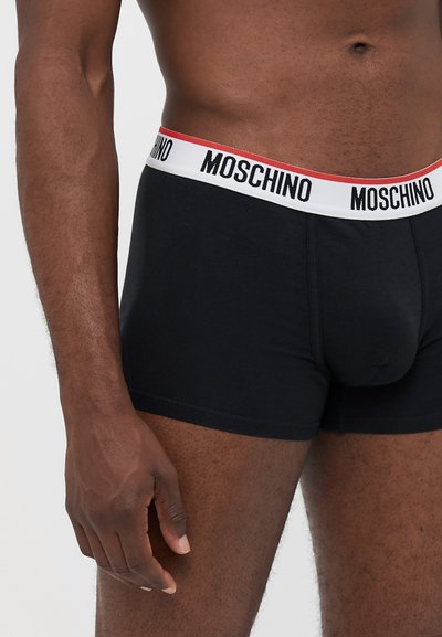 Black cotton boxer briefs with a white and red Moschino logo waistband. Features a snug fit and smooth texture.