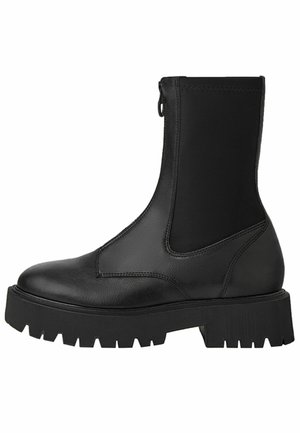 Botte en cuir noire mi-mollet avec semelle épaisse crantée, bout arrondi, panneau latéral élastique et fermeture éclair au dos.