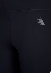 Sorte leggings lavet af et glat, strækbart stof har et hvidt geometrisk logo-design og flade sømme for et strømlinet udseende.