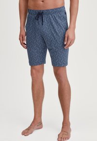 Marineblauwe zwembroek met een geometrisch patroon, verstelbare tailleband, boven de knie lengte, en een gladde katoenmix stof.