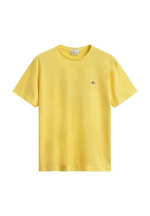 Gelbes Baumwoll-T-Shirt mit kurzen Ärmeln, rundem Ausschnitt und kleinem besticktem GANT-Logo auf der linken Brust.