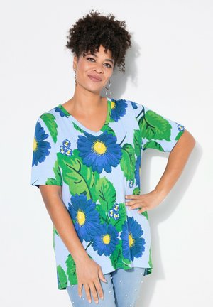 Blue floral t-shirt with short sleeves and a V-neck, featuring vibrant green leaves and yellow accents, made from soft cotton blend fabric.