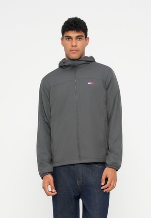 Gray lightweight jacket with a hood, featuring a zip front, elastic cuffs, and a small multi-color logo on the upper left chest.