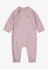 Lys rosa jumpsuit laget av mykt stoff, med glidelås foran, lange ermer og en liten rød logo detalj.