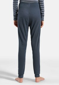 Gray ribbed pajama pants with a fitted ankle cuff, featuring a smooth texture and vertical lines, shown from the back with a simple waistband.