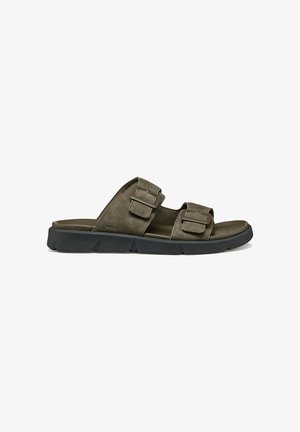 Dunkelgrüne Riemchensandalen mit zwei verstellbaren Riemen, aus weichem Leder gefertigt. Die leichte Gummisohle hat ein strukturiertes Profil für besseren Halt.