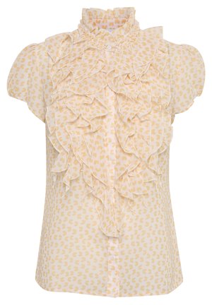 Blusa de manga corta en suave tejido amarillo con un cuello alto con volantes y un patrón de corazones en toda la prenda. Cierre frontal con botones.