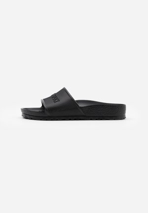 Black rubber slide sandal with textured upper, open toe design, and contoured sole for comfort. Features a pronounced brand logo on the strap.