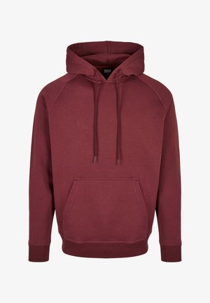 Bordowa bluza z kapturem z kieszenią frontową, sznurkami ściągającymi i prążkowanymi mankietami. Wykonana z miękkiego materiału o klasycznym wzornictwie i rękawach raglanowych.