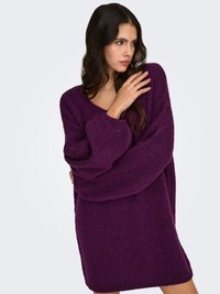 Oversized purple knit sweater with a V-neck, long sleeves, and textured fabric. Soft and chunky design with a relaxed fit.
