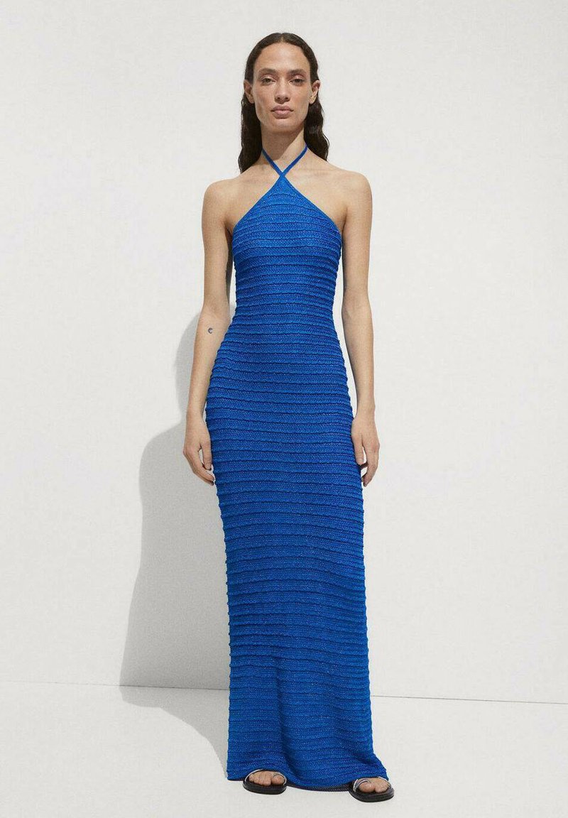 Blue halter neck maxi dress with textured horizontal stripes, fitted silhouette, and a smooth fabric finish. Black sandals worn.