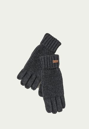 Par de guantes de lana tejidos en color gris oscuro con puños de canalé y una pequeña etiqueta de cuero marrón en un guante sobre un fondo claro.