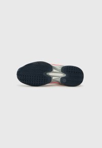 Tennis shoe outsole featuring a black rubber pattern, raised zigzag design, and a central gray plastic support structure.