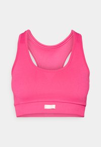 Lys rosa sømløs sports-BH med brede stropper og racerback-design, med en liten hvit merkeflagg på den fremre stroppen.