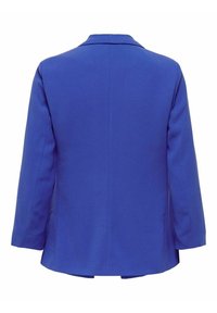 Blå blazer med en slät tyg, något överdimensionerad design, snedskuren krage och långa ärmar. Har en ren baksida utan synliga stängningar.