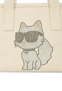 Geantă din pânză cu un design cu pisici, decorată cu strasuri, purtând ochelari de soare. Geanta este de culoare crem și are mânere rezistente.