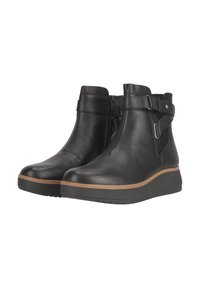 Bottines en cuir noir avec semelle en coin, dotées d'une fermeture éclair latérale et de détails de sangle ajustable. Tige texturée avec semelle en caoutchouc.