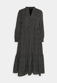 Schwarz-weiß gemustertes Kleid mit V-Ausschnitt, langen Ärmeln und gestuften Rock. Hergestellt aus leichtem Stoff mit einer weichen Textur.