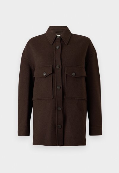 Veste-chemise en laine marron foncé à manches longues avec fermeture à boutons sur le devant et deux grandes poches poitrine à rabat boutonné sur fond uni.