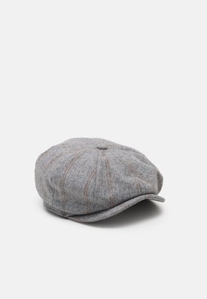 Grå tweed flad kasket med subtile brune striber og en lille skygge, lagt fladt mod en ensfarvet lys baggrund.