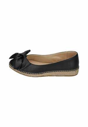 Black leather flat shoe with a large bow on the toe, beige woven sole, and tan interior lining.