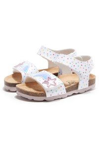 Sandales blanches à pois, avec des sangles ajustables, une semelle en liège, des accents d'étoiles violettes et une semelle en caoutchouc texturée. Présente un design ludique.