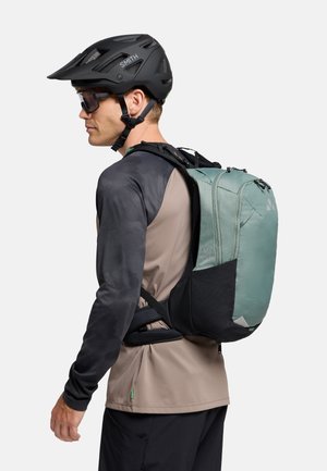 Zaino con corpo in tessuto verde menta, dettagli neri, spallacci regolabili e design elegante, adatto per ciclismo o per attività all'aperto.