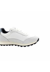 Scarpa sportiva bianca con tomaia in mesh, dettagli in suede morbido, suola in gomma e lacci piatti. Presenta un tallone rialzato e una suola nera.