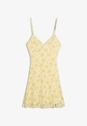 Rochie de vară galbenă cu imprimeu floral, bretele subțiri spaghetti și decolteu în V, dintr-un material ușor și fluid, cu o mică fante în tiv.