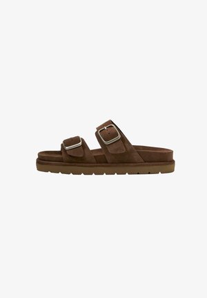 Brown suede slide sandal with two adjustable straps featuring large silver buckles and a thick textured sole.
