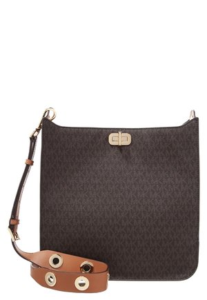 Brown crossbody bag with gold-tone clasp and adjustable tan leather strap featuring large gold grommets, textured with subtle repeating logo pattern.