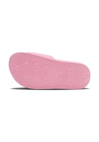 Pink rubber outsole with a textured pattern featuring raised circles and diamond shapes, designed for grip and durability.