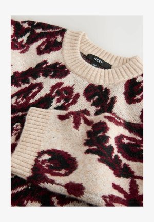 Knit sweater featuring a cream base with maroon and black floral patterns, classic ribbed round neckline and cuffs. Soft texture.