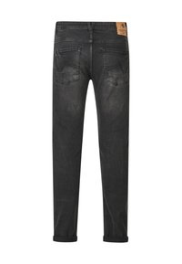 Black denim jeans with a straight cut, featuring a leather brand patch, two back pockets, and rolled hems. Smooth texture, minimal wear.