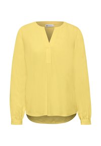 Blouse jaune à manches longues avec une fente en V et des poignets froncés, étiquetée "Street One", présentée sur un fond blanc.