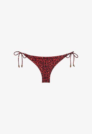 Bas de bikini à imprimé léopard rouge et noir avec des liens sur les côtés et de petits accents de perles sur un fond blanc.