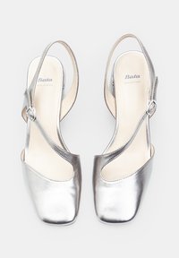 Silver leather slingback shoes with a rounded toe and cut-out side detail. Features a buckle strap for secure fit and smooth interior lining.