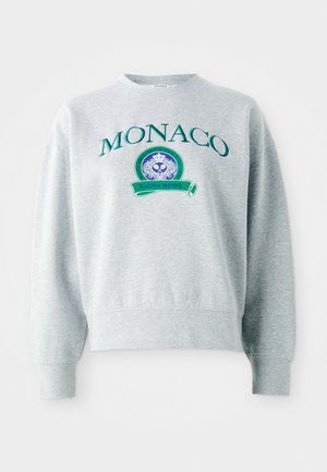 Grå hettegenser med grønn brodert "MONACO" tekst, med et rundt emblem med blå design og bånd med "BJÖRN BORG." Standard passform.