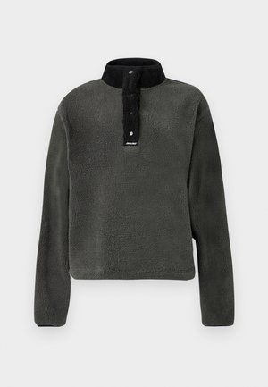 Σκούρο πράσινο φλις πουλόβερ με μαύρο ψηλό γιακά, διαθέτει κουμπιά σναπ και υφάσματος με υφή για επιπλέον ζεστασιά.