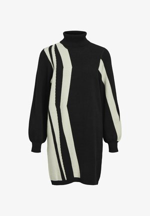 Must musterniga mustree, millel on kreemjas sälgiga muster, pika ballooni varrukaga ja lõdva istuvusega. Tekstuuriga kootud kangas.