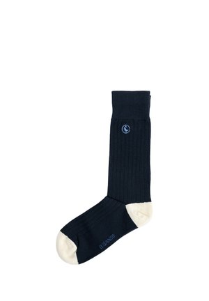 Calcetín negro acanalado individual con puntera y talón blancos, logotipo bordado de pájaro azul cerca del puño y texto "EL GANSO" en el lado del pie.
